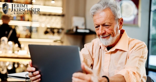 Older man holding a digital tablet